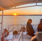 a group of people sitting in a boat on a body of water